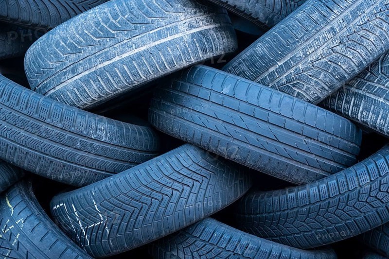 Pile of worn old tyres from passenger cars