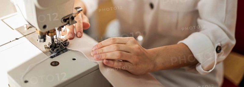 Close up woman working with sewing machine