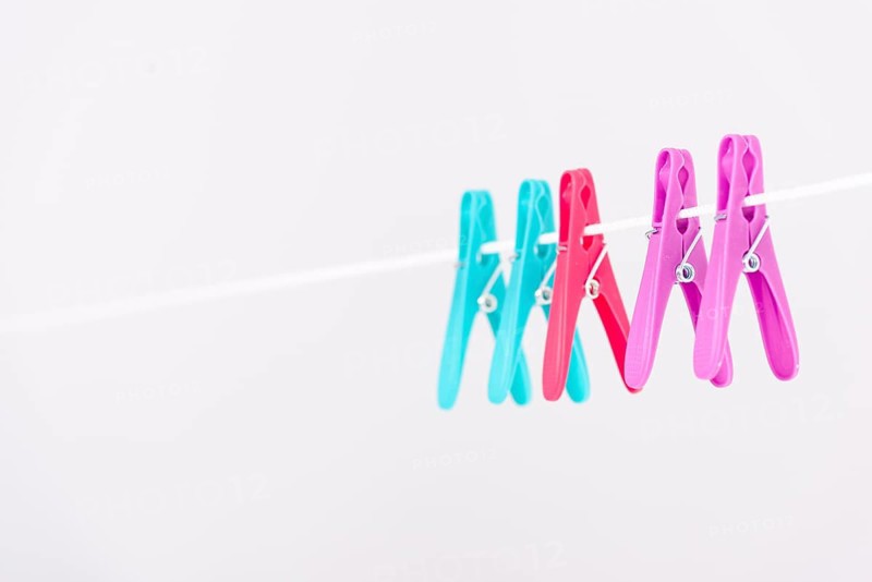 Colourful clothes pins hanging clothesline