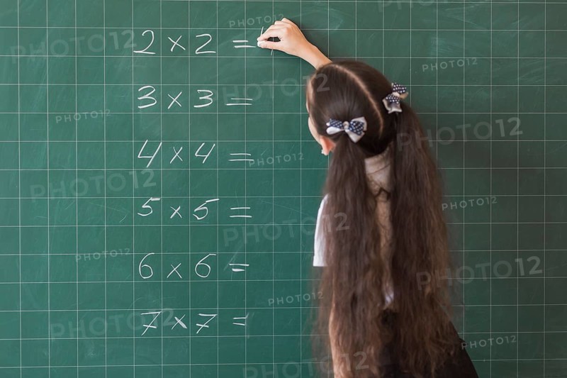Girl making calculations blackboard