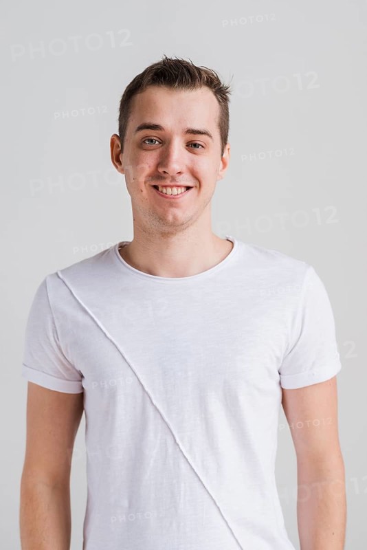 Smiling man white t shirt looking camera