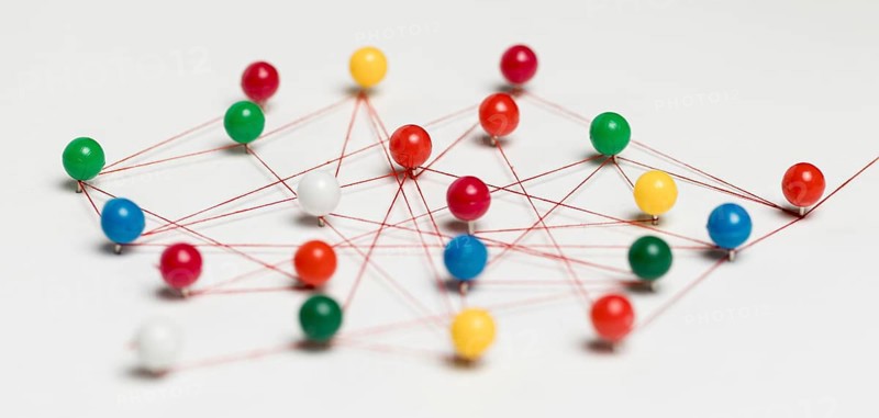 Colourful pushpins with thread route map