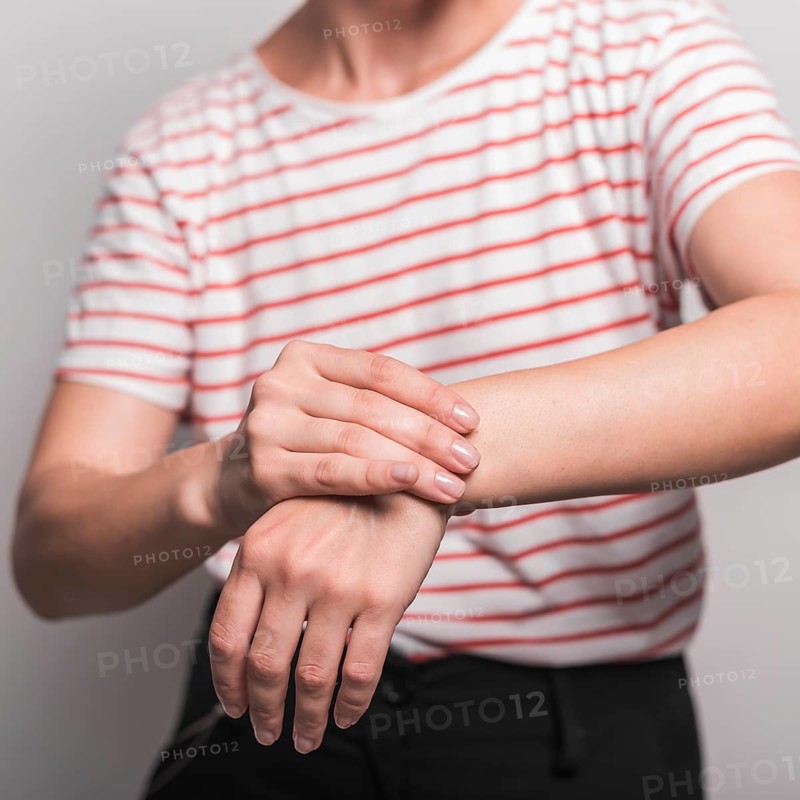 Mid section young woman having pain wrist