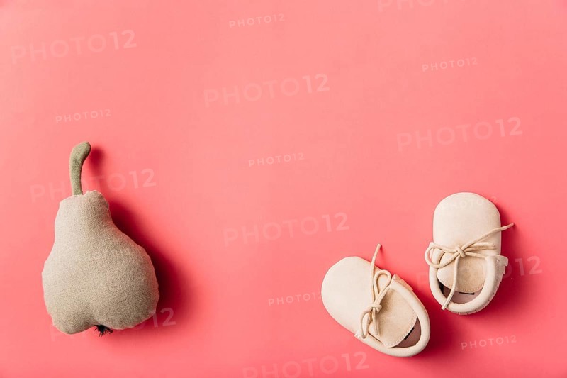 Stuffed pear fruit pair baby s shoes colored background