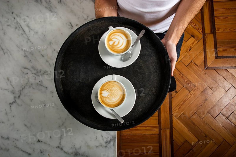 Two cups coffee with latte art tray