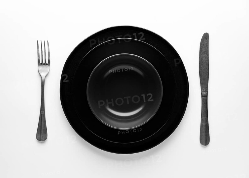 Flat lay dark dinnerware cutlery