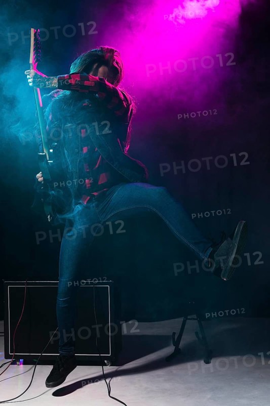 Artist playing guitar dancing