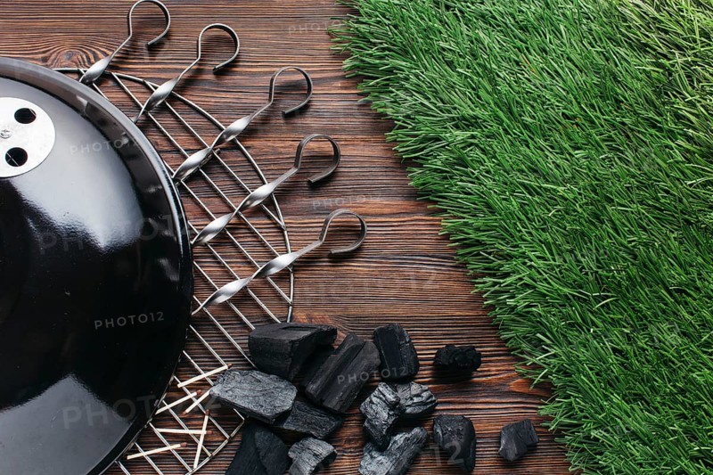 Grill grates with metallic skewer coal wooden textured