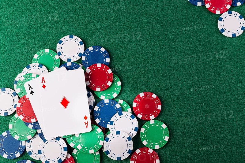 Two aces playing cards chips green poker table