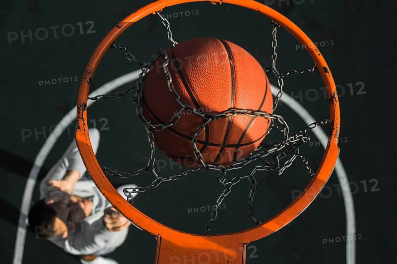 Basketball falling through ring