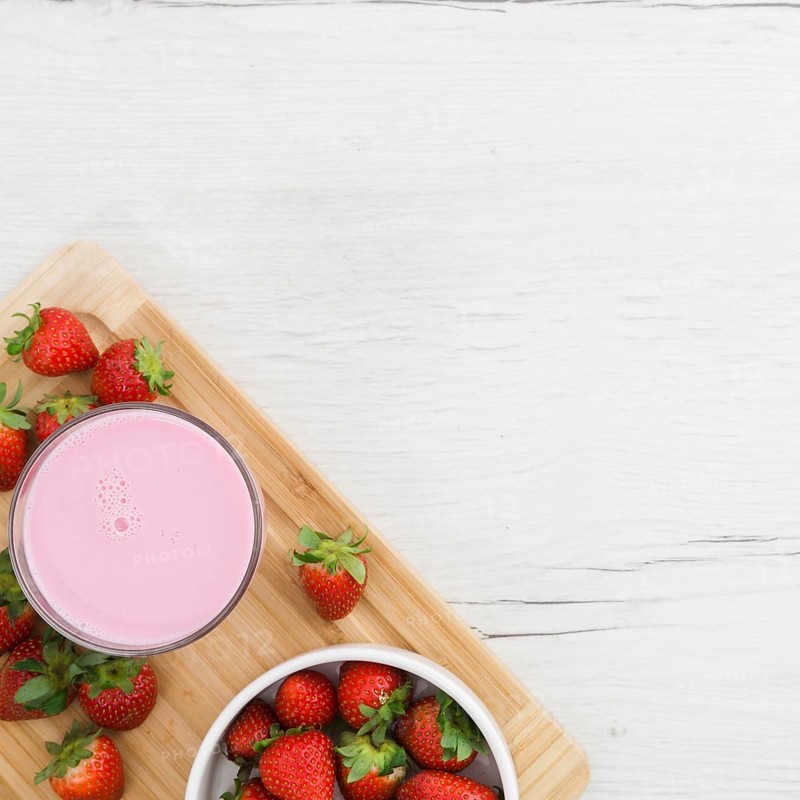 Flat lay strawberry smoothie with fruits