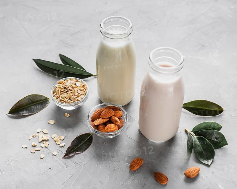 High angle milk bottles with almonds oats