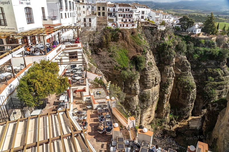 Restaurants high above Tajo de Ronda gorge and the white houses of La Ciudad old town
