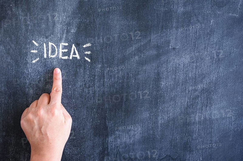 Person pointing finger idea text written chalk blackboard