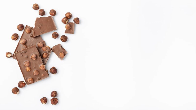 Top view chocolate with hazelnuts copy space