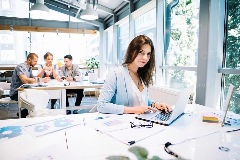 Woman laptop looking camera