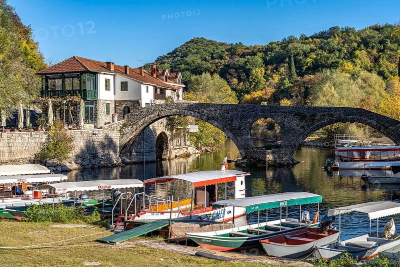 Excursion boats at the Old Bridge Stari Most over the river Crnojevic in Rijeka Crnojevica