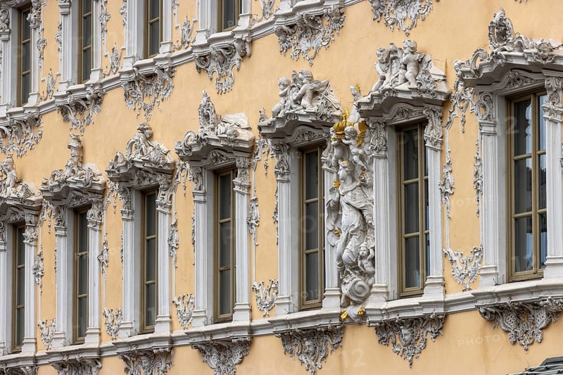 Windows of the Falcon House with stucco facade and rococo-style sculptures in the centre of Wuerzburg