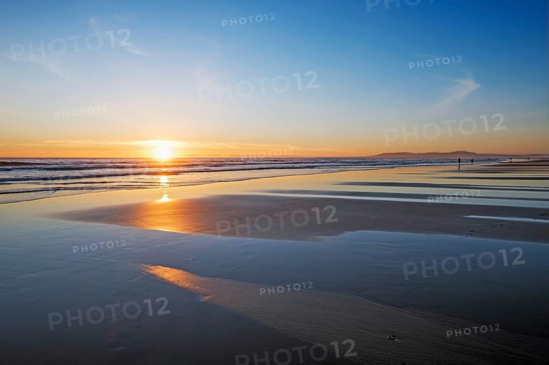 Atlantic ocean sunset with surging waves at Fonte da Telha beach