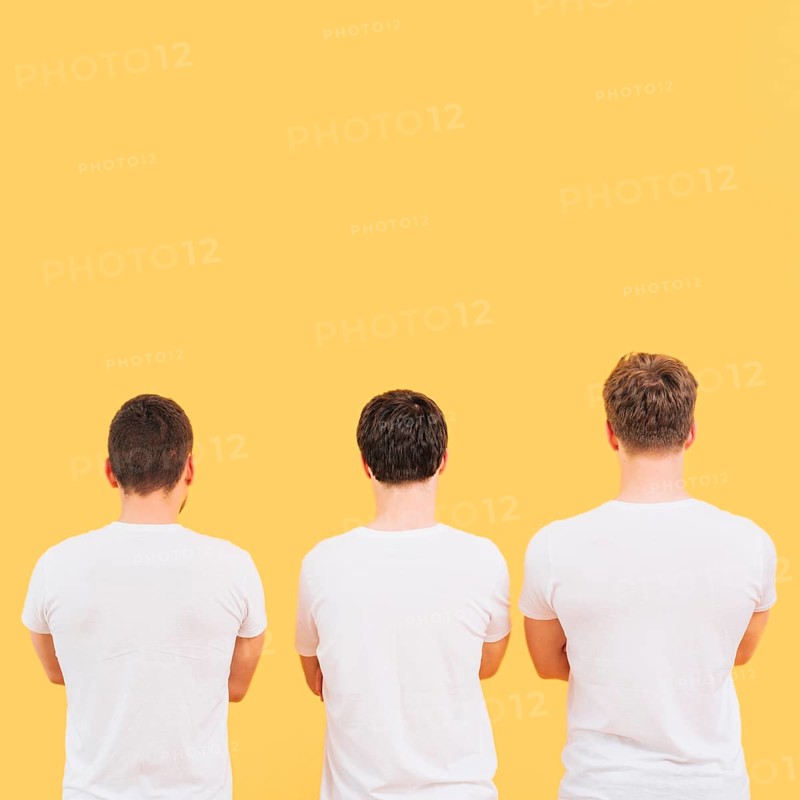 Rear view men white t shirt standing against yellow background