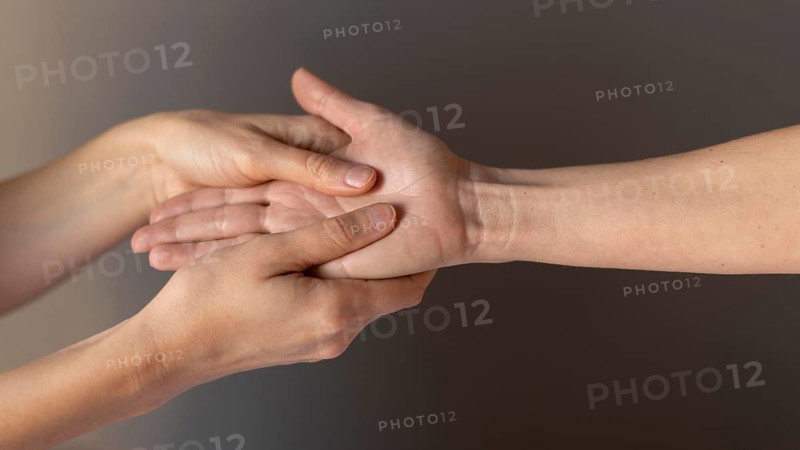 Close up hands massaging palm