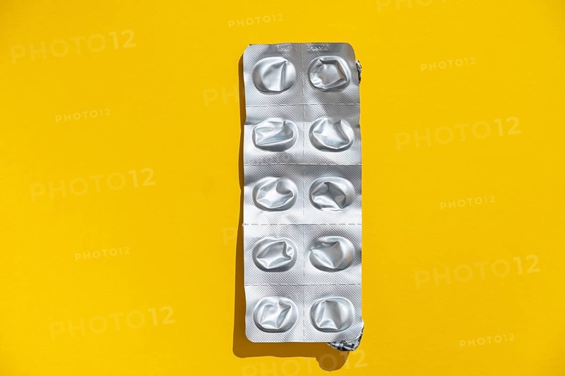 Empty tablet blister pack against a monochrome background