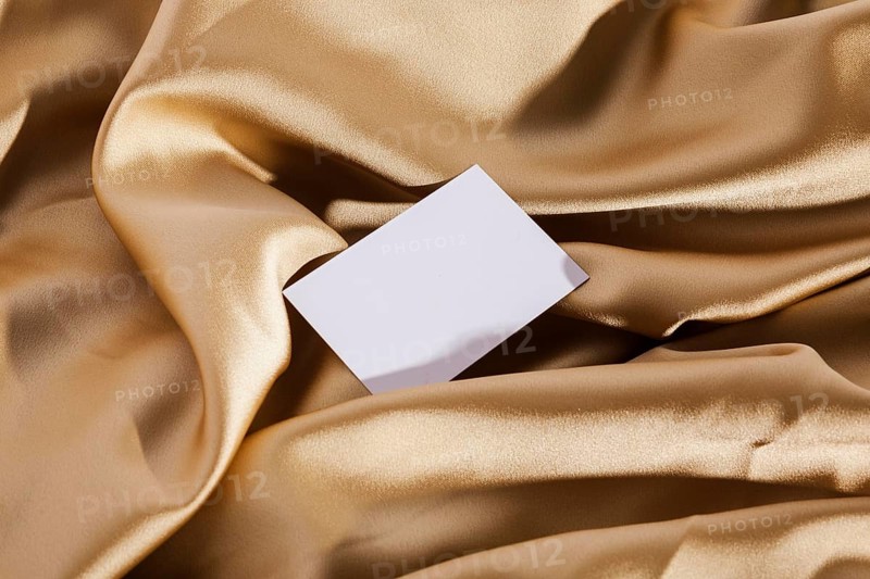 Top view white card golden cloth