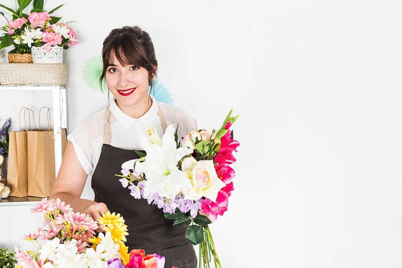 Portrait happy woman with bunch flowers