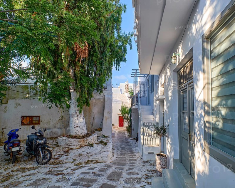 Charming traditional narrow streets and beautiful walkways of Greek island towns. Whitewashed houses