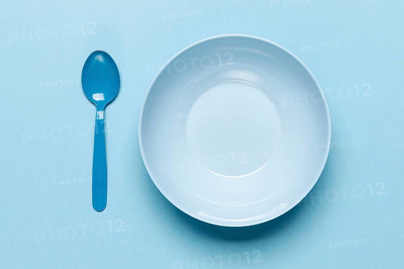 Top view empty blue bowl spoon