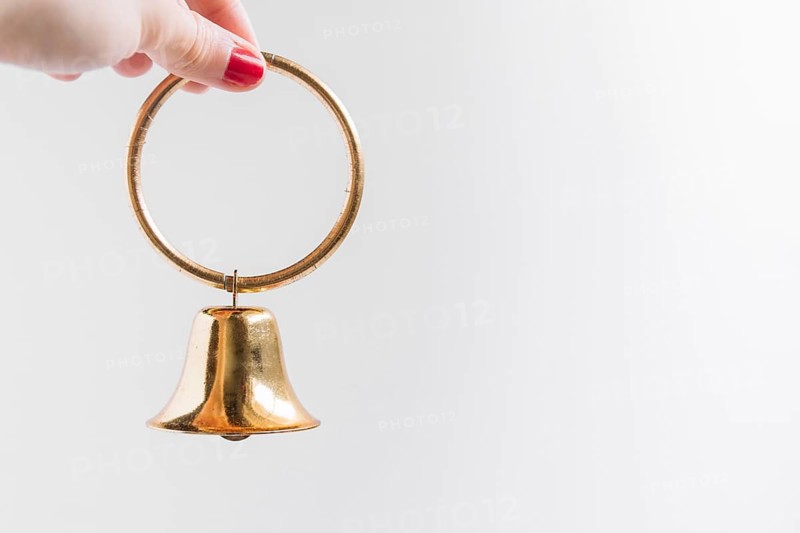 Woman holding small bell hand