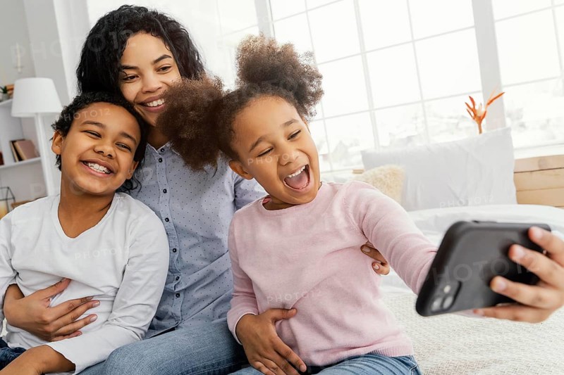 Smiley mother children taking selfie home