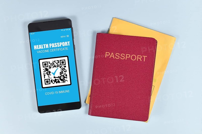 Concept for international Corona virus vaccine passport on mobile phone device to allow vaccinated people privileges like traveling