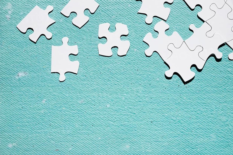 White jigsaw puzzle piece blue textured surface