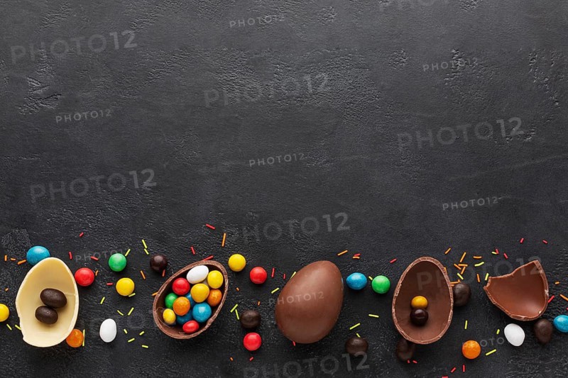 Top view chocolate easter eggs filled with colorful candy
