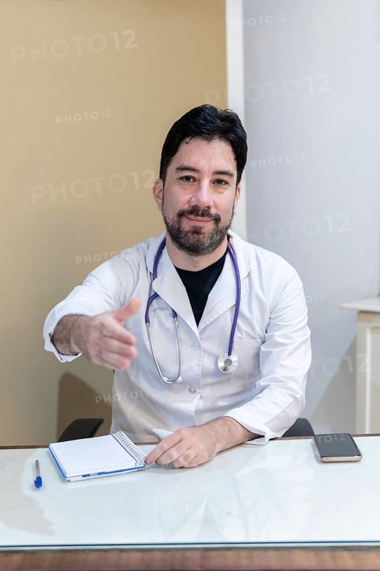 Latin doctor sitting at his desk