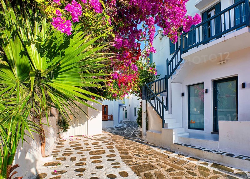 Romantic traditional narrow streets and beautiful walkways of Greek island towns. Whitewashed houses