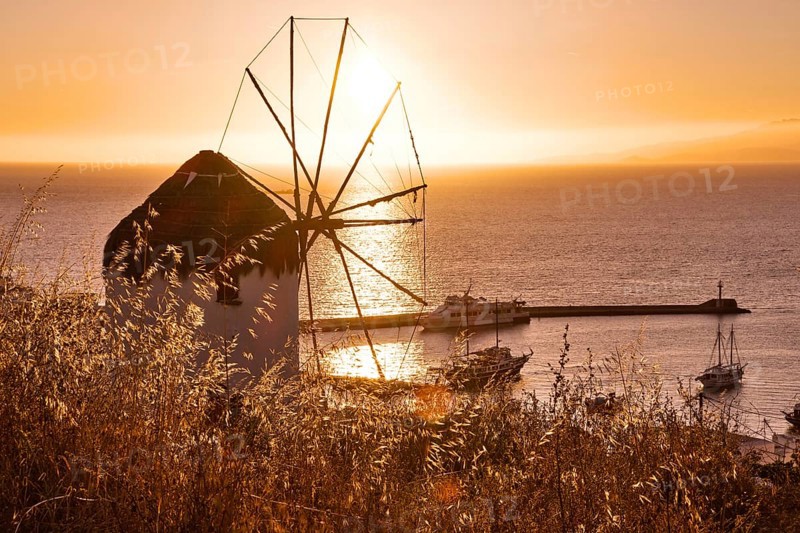 Golden sunset over sea horizon in Mykonos