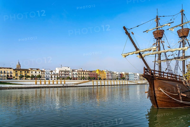 Replica of the Nao Victoria 500 and the colourful houses of the Triana district on the Guadalquivir River
