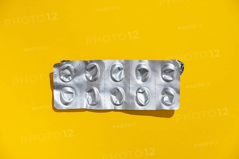 Empty tablet blister pack against a monochrome background