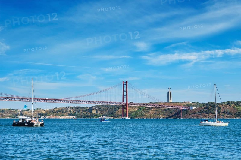 View of 25 de Abril Bridge famous tourist landmark over Tagus river