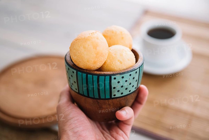 Person holding cheese balls bowl