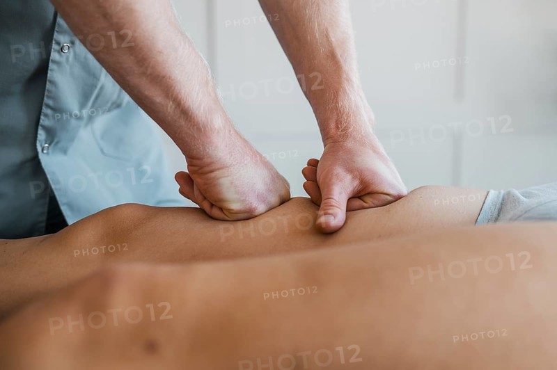 Male physiotherapist massage session with female patient