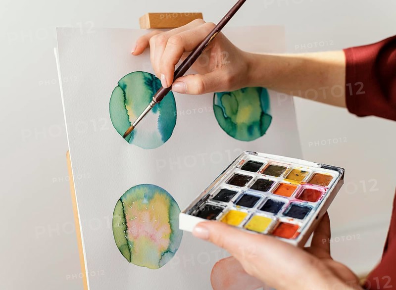 Young artist painting with watercolors