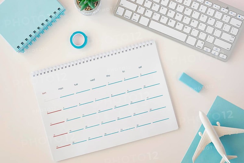 Flat lay planner calendar with blue accessories