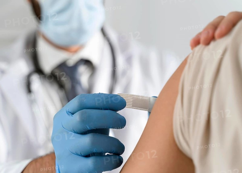 Man putting bandage young woman s arm