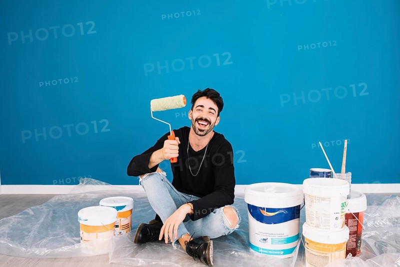 Smiling man showing paint roll