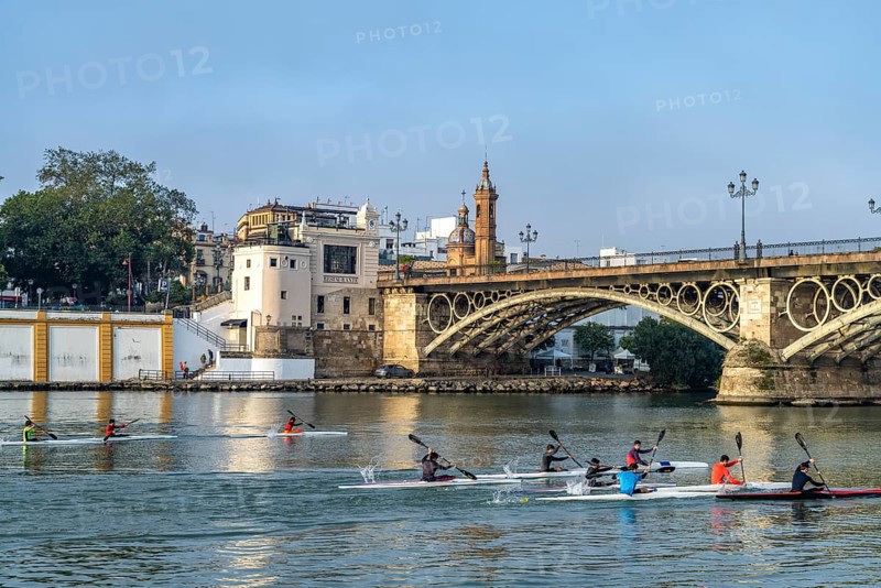 Kayaks on the Guadalquivir River at the Puente de Isabel II Bridge
