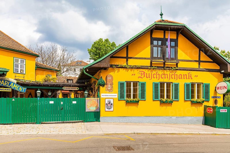 Buschenschank with yellow facade and green shutters