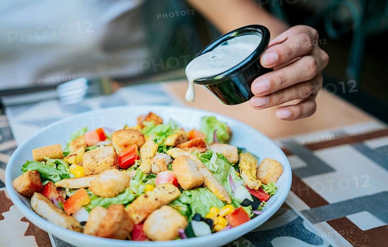 Close up of hand preparing a vegetable salad. Concept of healthy food and lifestyle